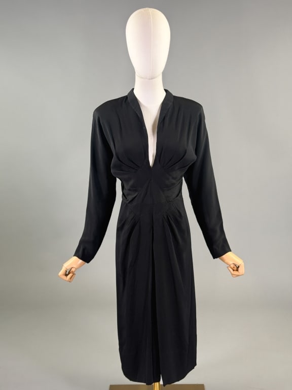 Vintage 1940s Black Rayon Crepe Cocktail Dress: Vintage 1940s Black Rayon Crepe Cocktail Dress having v-neckline with pleated details through front and center back zip closure. Measuring 34 inch bust, 28 inch waist, 43 inches long, 20 inch sleeve l