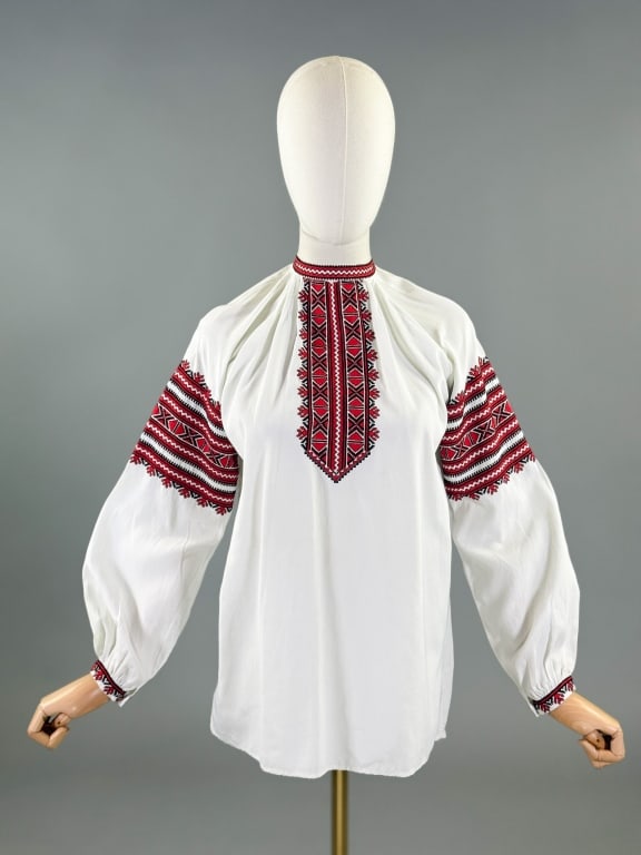 Vintage 1970s Ukranian Embroidered Vyshyvanka Top: Vintage 1970s Ukranian Embroidered Vyshyvanka Top having embroidery down front and sleeves with center back zip at neck. Measuring 40 inch chest, 26 inches long, 21 inch sleeve length.