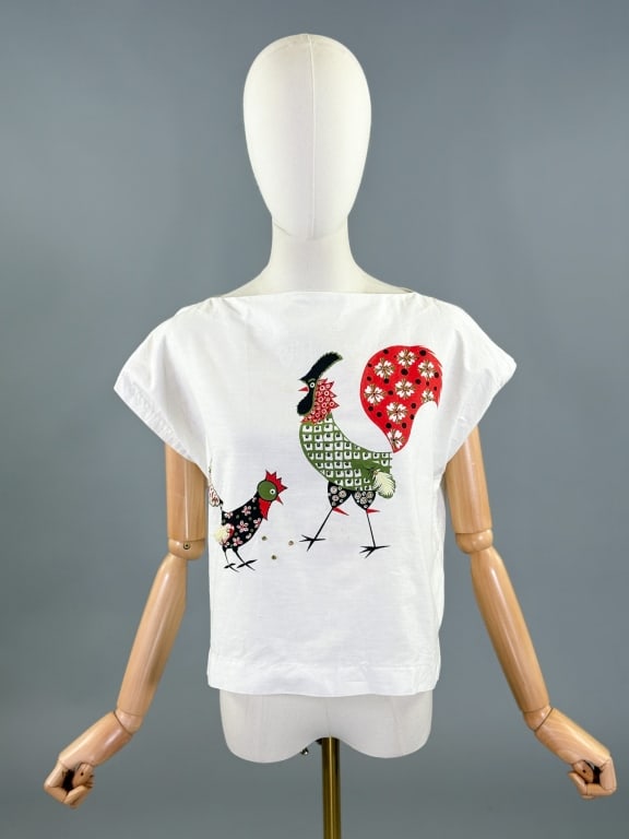 Vintage 1950s Cotton Boat Neck Chicken Blouse Top: Vintage 1950s Cotton Boat Neck Chicken Blouse Top having chicken print and metal stud details at front, slides over head, no closures. Measuring 40 inch bust, 19 inches long.