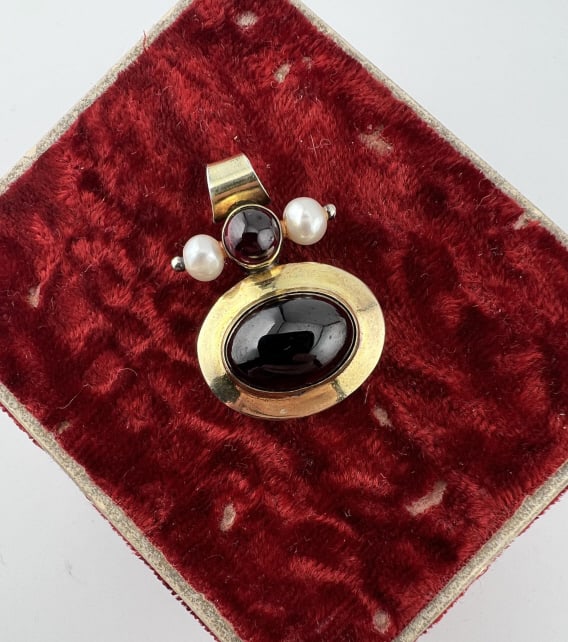 Gold Over Sterling Silver Garnet & Pearl Pendant: Gold Over Sterling Silver Garnet & Pearl Pendant. Set with two garnet cabochons and accent pearls. Signed MMA 925. Measures 1.25 inches in length.