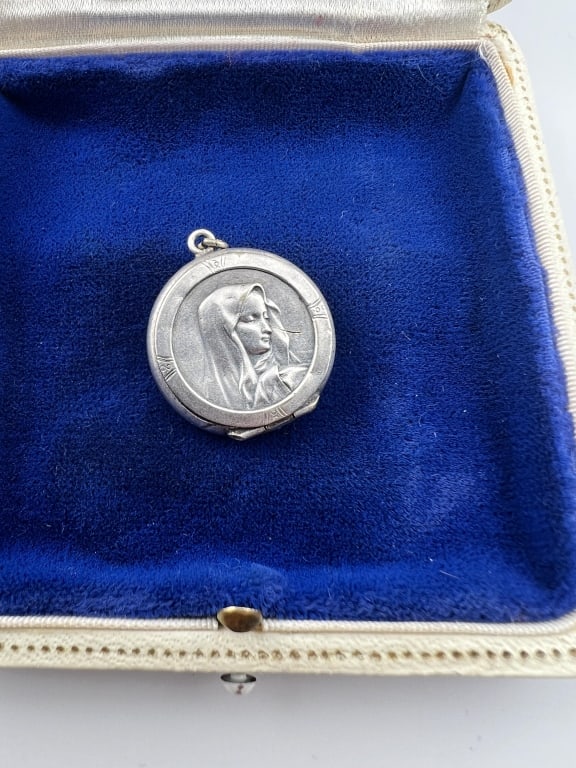 Antique Silver Virgin Mary Locket Necklace Pendant: Antique Silver Virgin Mary Locket Necklace Pendant. Silver reliquary or locket pendant with a portrait of the Madonna on the front. Apparently unmarked. Measures 1.25 inches in length.