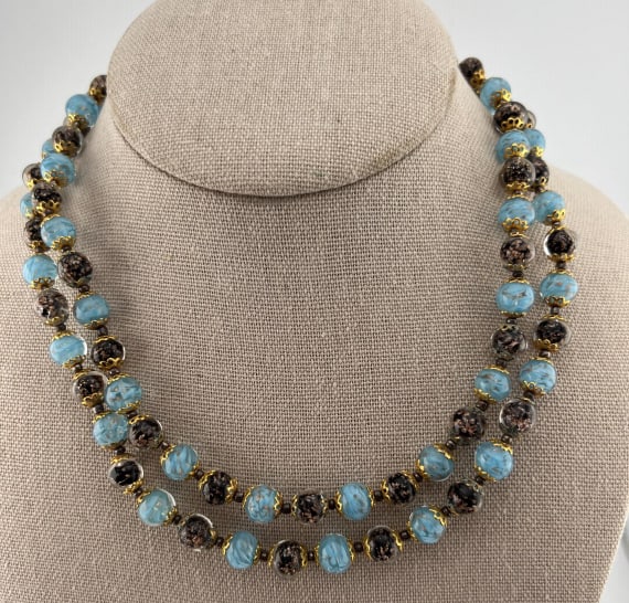 Vintage Italian Murano Glass Beaded Necklace: Vintage Italian Murano Glass Beaded Necklace. Double strand necklace with gilt metal fittings and beads that have gold flecks in side of them. Longer strand measures approximately 18 inches in length.