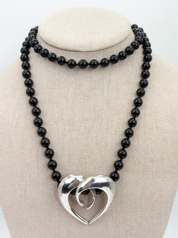 Vintage Onyx & Sterling Heart Pendant Necklace: Vintage Onyx & Sterling Heart Pendant Necklace. Hand knotted on black thread. Measures approximately 30 inches in length.