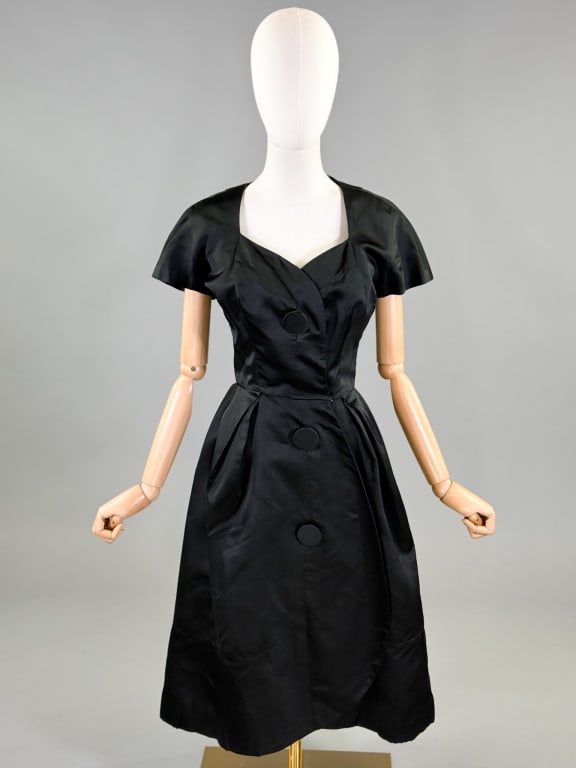 Vintage 1950s Black Silk Satin Button Dress: Vintage 1950s Black Silk Satin Button Dress having large covered button closure at center front. Measuring 36 inch bust, 26 inch waist, 42 inches long, 6 inch sleeve length. Wear and small holes as sh
