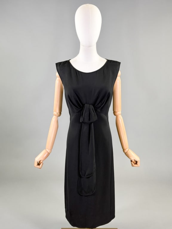Vintage 1950s Little Black Silk Cocktail Dress: Vintage 1950s Little Black Silk Cocktail Dress having tie detail at center front with ruched bust and center back button & zip closure, fully lined. Measuring 38 inch bust, 34 - 38 inch waist, 40 inch