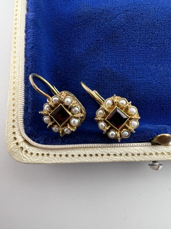 Pair of Gold Over Silver Garnet & Pearl Earrings: Pair of Gold Over Silver Garnet & Pearl Earrings. Gold plated over sterling silver earrings with garnets at center and pearl halos. Each measures just under 1 inch in length, approximately 7/8ths of a