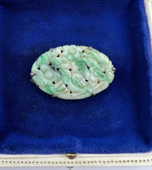 Antique Chinese Art Deco Jade & Sterling Brooch: Antique Chinese Art Deco Jade & Sterling Brooch. Sterling silver framed brooch with carved Chinese jade oval panel. Hallmarked on back. Measures just over 1.5 inches in width.