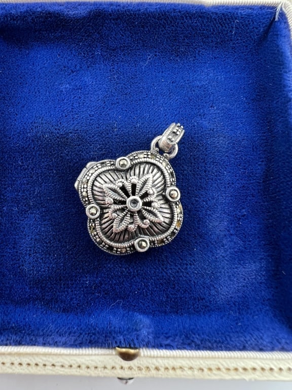 Sterling & Marcasite Quatrefoil Locket Pendant: Sterling Silver & Marcasite Quatrefoil Locket Necklace Pendant. Hallmarked. Measures 1.25 inches in length.