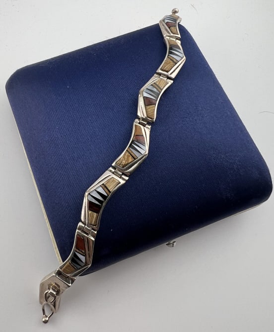 Sterling Silver Native American Zuni Bracelet: Sterling Silver Native American Zuni Bracelet. Articulated panel bracelet, signed and hallmarked. Measures approximately 6 inches in length.