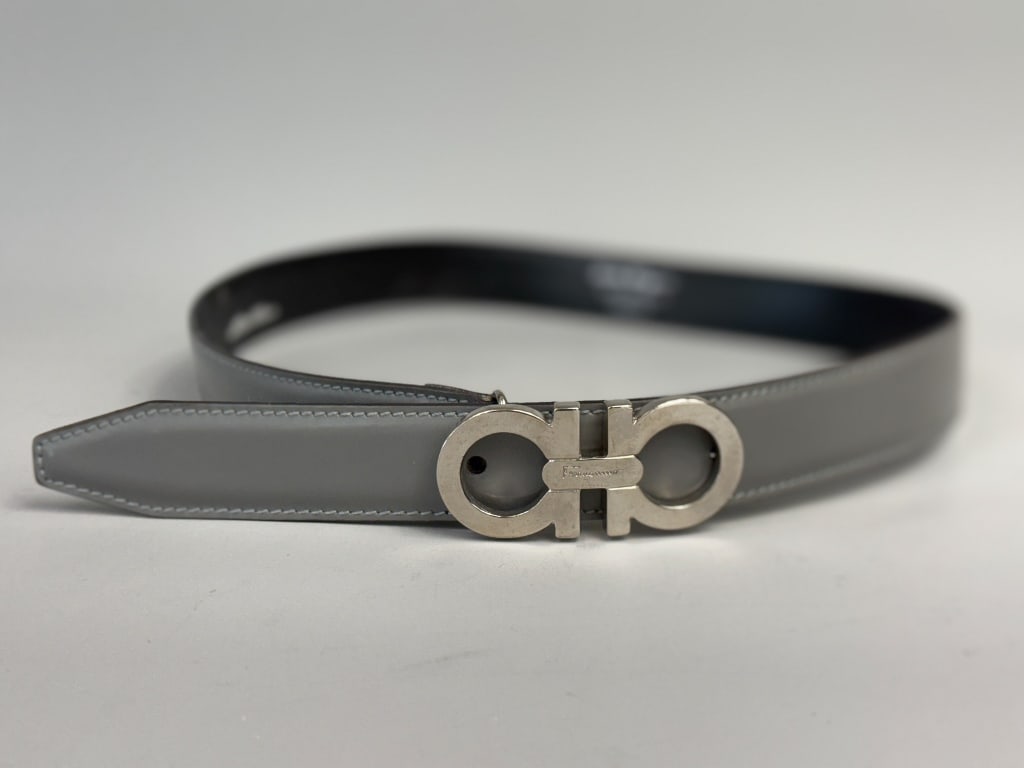 Vintage Salvatore Ferragamo Gancini Buckle Belt: Vintage Salvatore Ferragamo Gancini Buckle Belt having silver tone buckle with holes accommodating sizes 27, 28, and 29 inch waist. Labeled Salvatore Ferragamo Made in Italy 236134. General wear throu