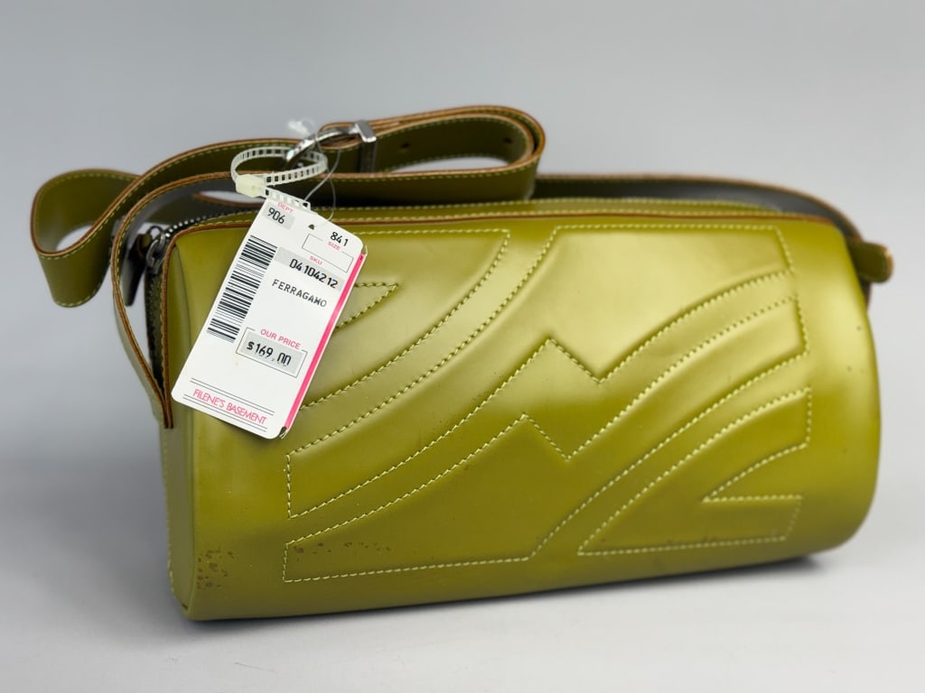 Vintage Salvatore Ferragamo Green Leather Purse: Vintage Salvatore Ferragamo Green Leather Purse having barrel shape with adjustable shoulder strap, geometric stitching, top zip closure with interior zip pocket. Measuring approximately 10 inches wid