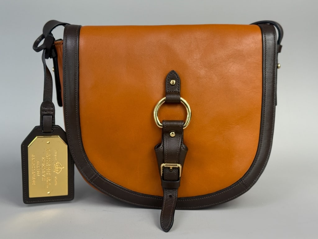 Vintage Ralph Lauren Leather 1967 Saddle Bag Purse: Vintage Ralph Lauren Leather 1967 Saddle Bag Purse having gold tone ring and buckle detail at front with magnetic snap closure, single interior zip pocket with adjustable cross body strap. Labeled Lau