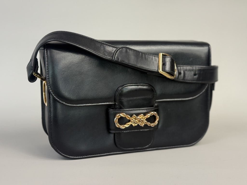 Vintage 1960s Saks Fifth Avenue Leather Box Bag: Vintage 1960s Saks Fifth Avenue Leather Box Bag having adjustable shoulder strap with gold tone metal bow detail at front closure. Labeled Saks Fifth Avenue Genuine Leather. Measuring approximately 10
