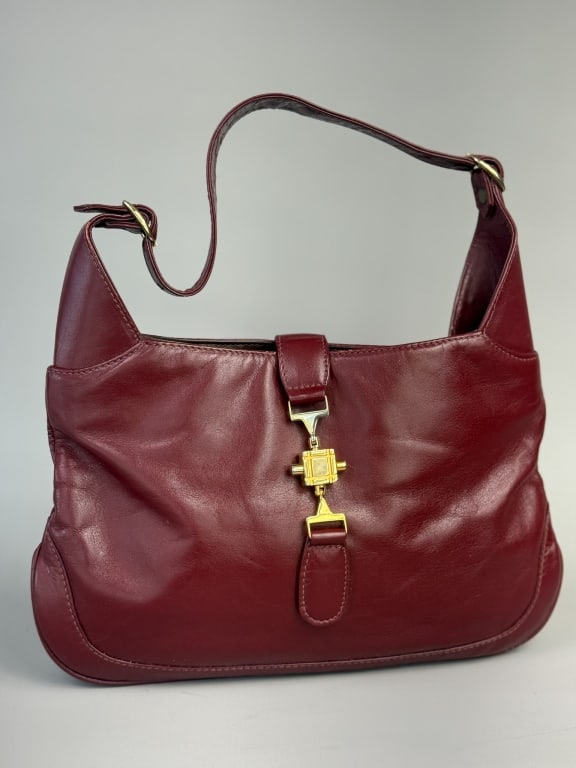 Vintage 1960s Saks Fifth Avenue Leather Hobo Bag: Vintage 1960s Saks Fifth Avenue Leather Hobo Bag having gold tone lock closure at front with adjustable shoulder strap. Labeled Saks Fifth Avenue Made in Uruguay. Measuring approximately 12 inches wid