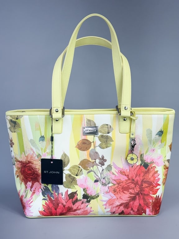 St. John Leather Floral Print Tote Bag Purse: St. John Leather Floral Print Tote Bag Purse with zippered top closure and interior pockets, floral charm, and original tag attached. Comes with dust bag. Measuring approximately 18 inches wide by 11 