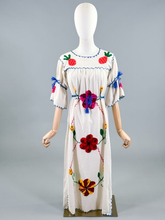Vintage 1970s Mexican Floral Embroidered Dress: Vintage 1970s Mexican Floral Embroidered Dress having colorful embroidery throughout with tie at waist and sleeves. Measuring 36 - 40 inch bust, 47 inches long, 12 inch sleeve length. General wear, co