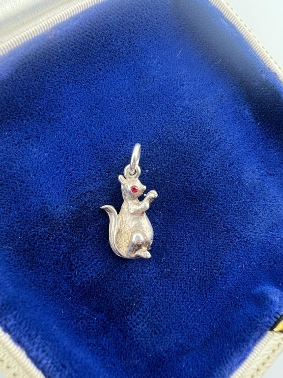 Vintage Sterling Silver Squirrel Pendant Charm: Vintage Sterling Silver Squirrel Pendant Charm Stamped STER, holding an acorn and having jeweled eyes. Measures approximately 1 inch in length.