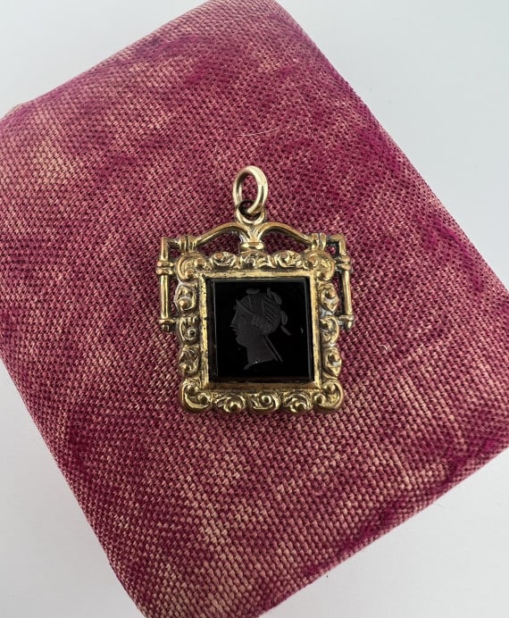 Antique 19th C Black Onyx Intaglio Fob Pendant: Antique 19th C Black Onyx Intaglio Fob Pendant. Necklace pendant or watch chain fob. Set with a Greco Roman style intaglio in black onyx within gold filled frame. Measures just under 1.25 inches in le