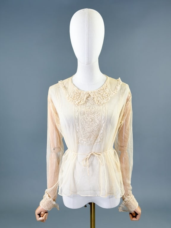 Antique 1900s Floral Embroidered Net Blouse Top: Antique Edwardian 1900s Floral Embroidered Net Blouse Top having ruffled collar with embroidery at chest, collar, and cuffs, closing at back neck with snap and sleeve cuffs with buttons. Measuring 38 