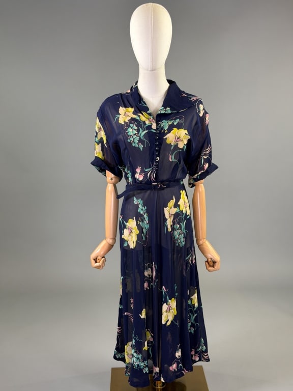 Vintage 1940s Rayon Chiffon Floral Print Day Dress: Vintage 1940s Rayon Chiffon Floral Print Day Dress having button front closure with side zip and belt at waist. Measuring 40 - 46 inch bust, 32 - 38 inch waist, 43 inches long, 8 inch sleeve length. G