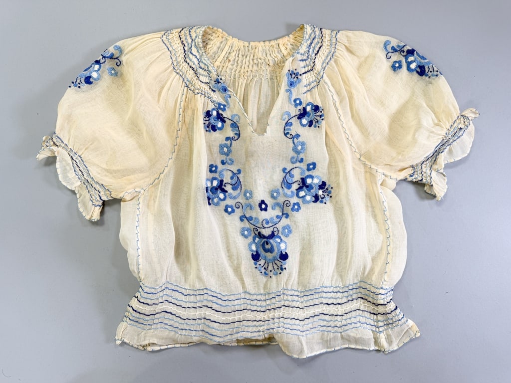 Vintage 1930s Hungarian Embroidered Folk Blouse: Vintage 1930s Hungarian Floral Embroidered Folk Blouse having smocking throughout with floral embroidery, closing at side with snaps. Measuring 34 inch bust, 26 inch waist, 17 inches long, 10 inch sle