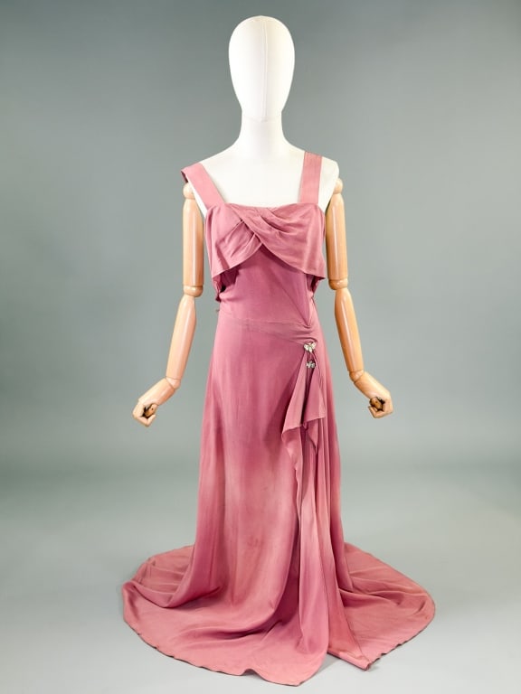 Vintage 1940s Volup Crepe Sleeveless Evening Gown: Vintage 1940s Rayon Crepe Sleeveless Evening Gown having draped bust with draped details through skirt with rhinestone butterfly pins at waist, closing at side with zip. Measuring 42 inch bust, 36 inc