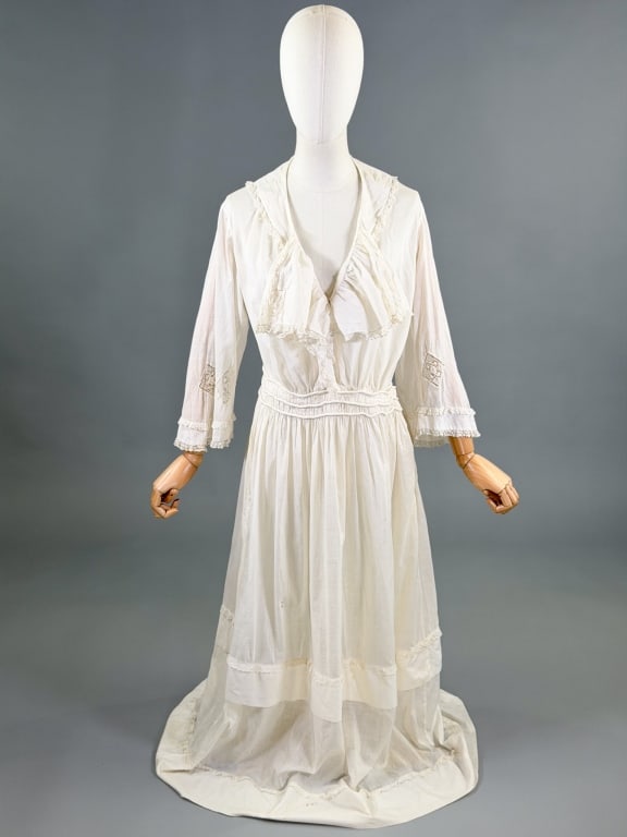 Antique Edwardian 1900s Cotton Lace Tea Lawn Dress: Antique Edwardian 1900s Cotton Lace Tea Lawn Dress having ruffled neckline, corded waist details, and snap closures at front with lace throughout. Measuring 34 - 40 inch bust, 30 inch waist, 53 inches