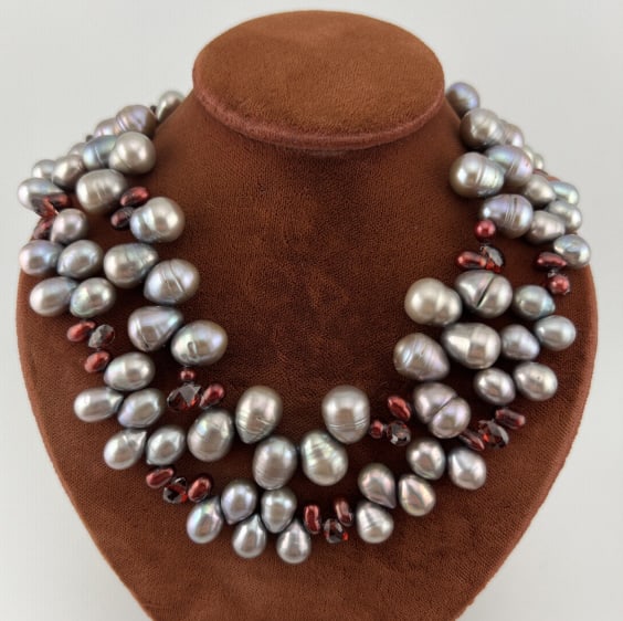 Baroque Cultured Pearl & Briolette Garnet Necklace: Baroque Cultured Pearl & Briolette Garnet Necklace. Two strand necklace with toggle clasp. Set with varying size high luster silver tone Tahitian cultured baroque pearls and briolette faceted garnets.