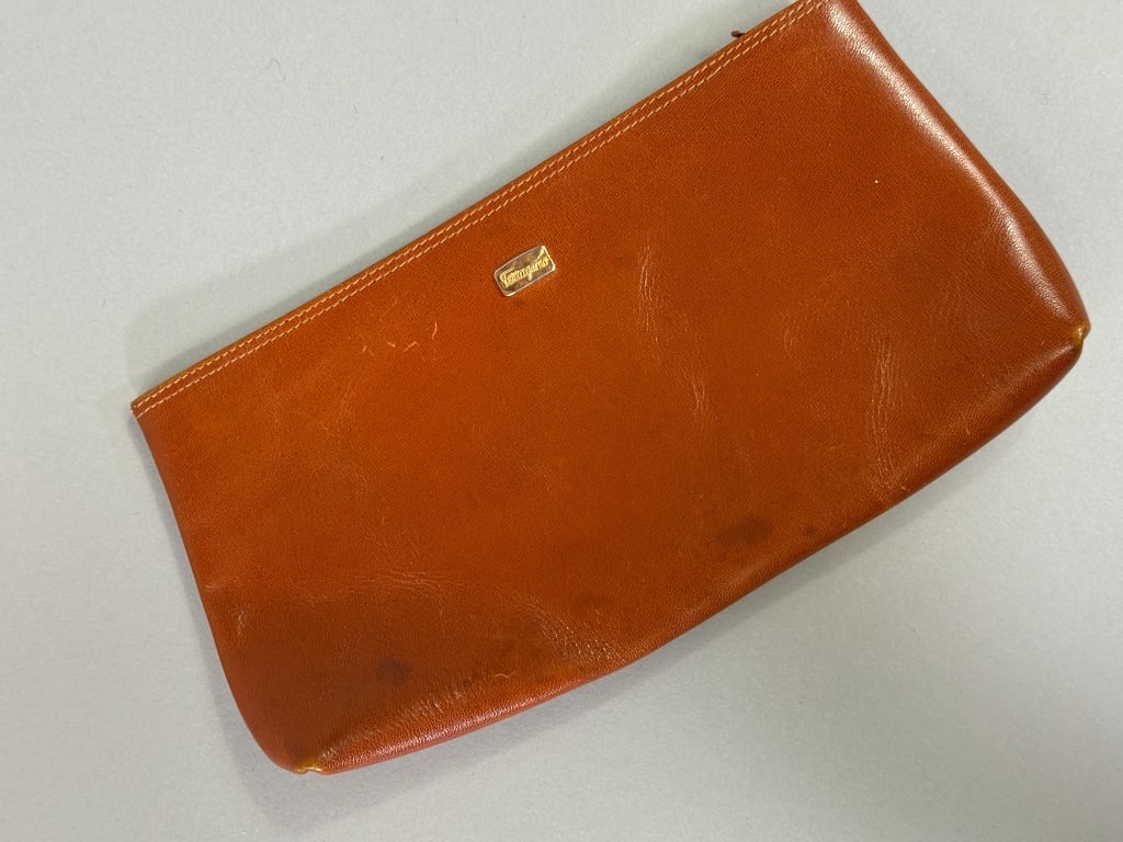 Vintage Salvatore Ferragamo Brown Leather Wallet: Vintage Salvatore Ferragamo Brown Leather Wallet with zip top closure and leather lining. Labeled Salvatore Ferragamo Made in Italy. Measuring approximately 4 inches by 7.5 inches by 1 inch. Wear as s