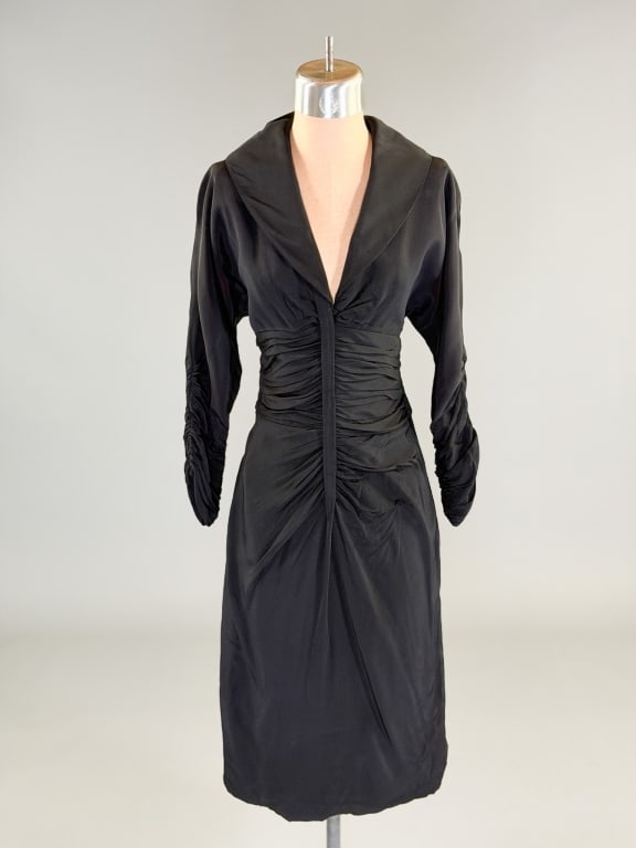 Vintage 1950s Ceil Chapman Silk Wiggle Dress: Vintage 1950s Ceil Chapman Silk Wiggle Dress having shawl collar at neck and ruched up center front and at sleeves with side zip closure. Measuring 32 inch bust, 24 inch waist, 38 inches long, 15 inch