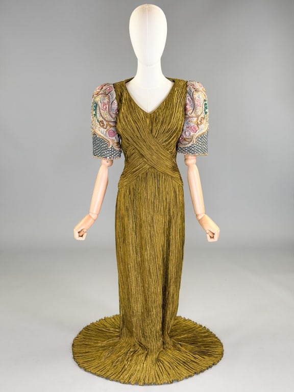 Vintage 1990s Mary McFadden Beaded Pleated Gown: Vintage 1990s Mary McFadden Beaded Pleated Gown, having side zip closure. Marked size 12. Measuring 32-38 inch bust, 26 to 32 inch waist, 58 inches long, 14 inch sleeve length.
