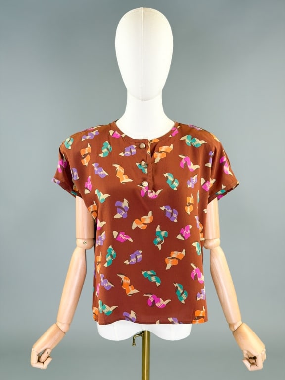Vintage 1980s Emanuel Ungaro Silk Printed Blouse: Vintage 1980s Emanuel Ungaro Silk Printed Blouse having quarter button placket at front, labeled Ungaro Parallele, marked size 12. Measuring 42 inch bust, 23 inches long, 5 inch sleeve length. General