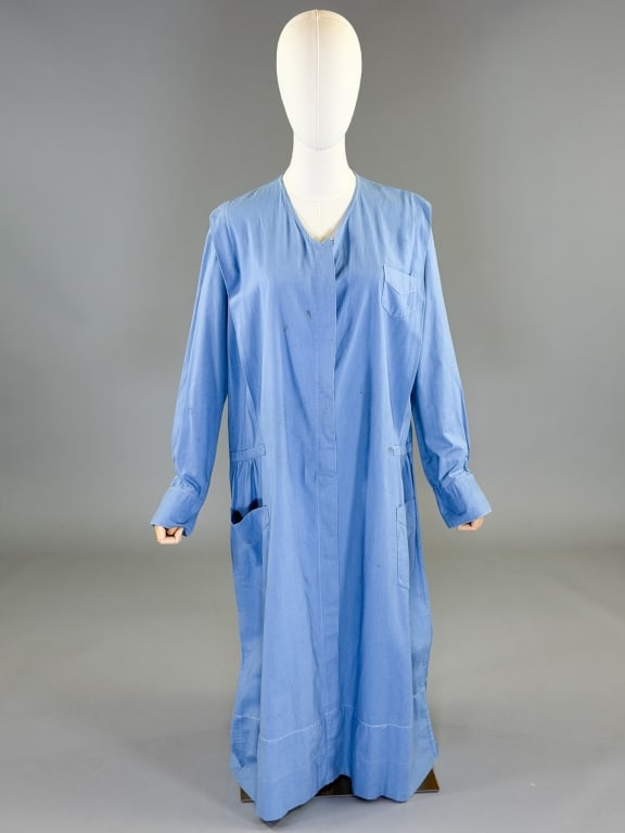 Vintage 1920s Cotton Work Uniform Dress: Vintage 1920s Cotton Work Uniform Dress having covered button front closure with front pockets and ruched drop waist. Measuring 46 inch bust, 50 inch drop waist, 48 inches long, 24 inch sleeve length.