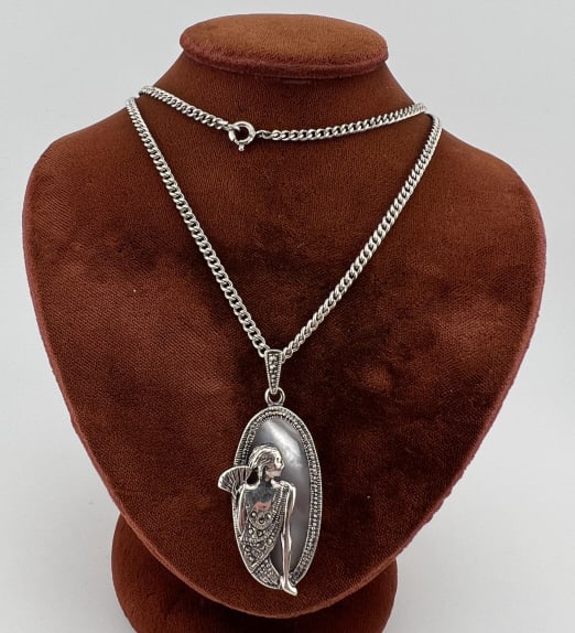 Art Deco Sterling Silver & Mother of Pearl Pendant: Art Deco Sterling Silver & Mother of Pearl Necklace Pendant. Scene of a woman folding a fan in the Art Deco style with mother of pearl plaque on chain and having marcasite details. Back of the pendant