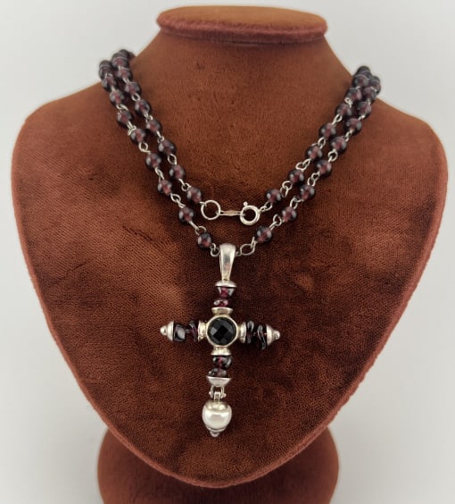 Sterling Garnet & Pearl Cross Pendant on Necklace: Sterling Silver Garnet & Pearl Cross Necklace Pendant on Beaded Necklace Chain. Clasp is hallmarked. Necklace strand measures approximately 24 inches in length, cross is just under 2 inches in length.