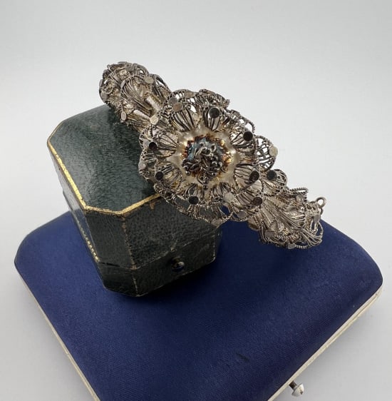 Antique Filigree Silver Hinged Bangle Bracelet: Antique Filigree Silver Hinged Bangle Bracelet w Floral Motif. Hinged bangle bracelet with safety chain at clasp. Measures just over 2.25 inches across the interior opening.