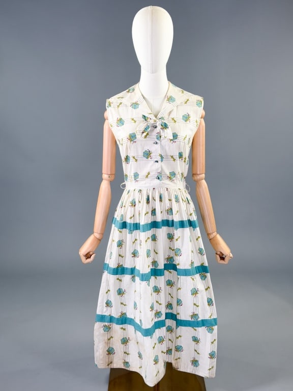 Vintage 1950s Cotton Present Novelty Print Dress: Vintage 1950s Cotton Present Novelty Print Day Dress having sailor collar, button front closure, and side zip. Measuring 36 inch bust, 26 inch waist, 45 inches long. General wear and spots as shown th