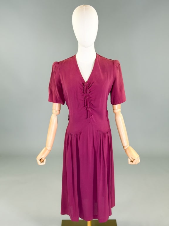 Vintage 1940s Rayon Crepe Tassel Day Dress: Vintage 1940s Crepe Tassel Day Dress having side button closure. Measuring 38-40 inch bust, 28-32 inch waist, 41 inches long, 11 inch sleeve length. General wear throughout as shown.