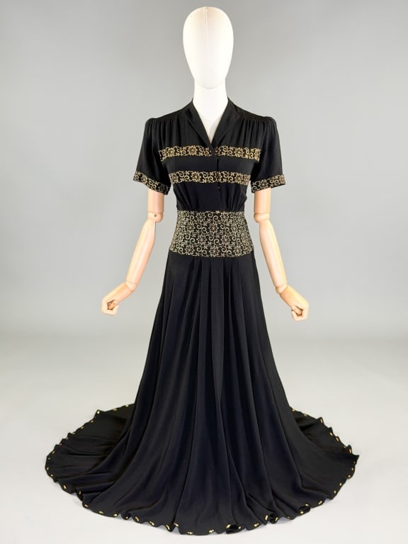 Vintage 1940s Crepe Lame Embroidered Evening Gown: Vintage 1940s Crepe Lame Embroidered Evening Gown having ruching through shoulders with snap front and side zip closures, lame metal embroidery through bodice and metal stud details at hem. Measuring 