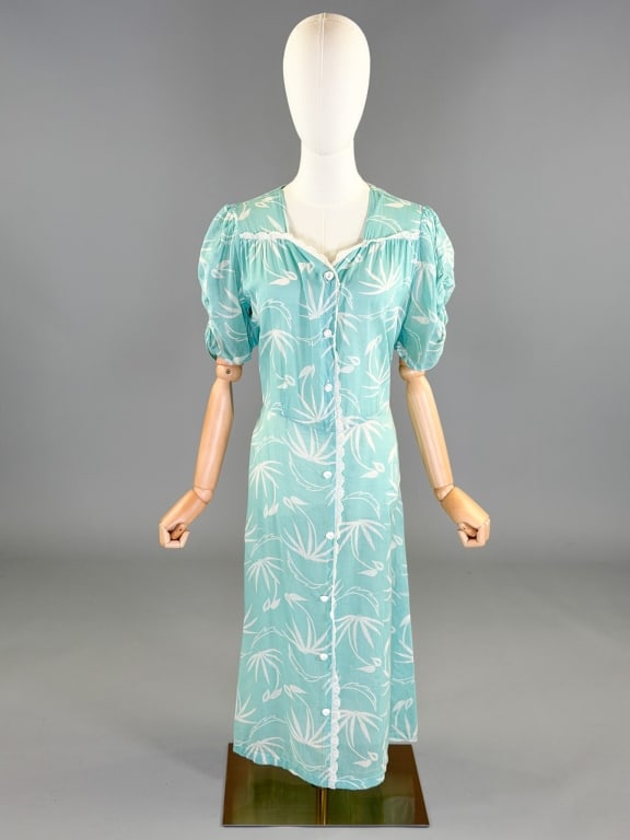 Vintage 1940s Cotton Button Front House Day Dress: Vintage 1940s Cotton Button Front House Day Dress having short puffed sleeves, button front closure, and lace trim details. Measuring 44 inch bust, 40 inch waist, 45 inches long, 10 inch sleeve length