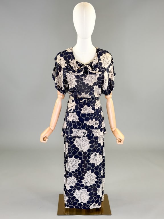 Vintage 1940s Rayon Figural Novelty Print Dress: Vintage 1940s Rayon Figural Novelty Print Dress having cowl neckline with center back zip closure, peplum at waist, and removable belt. Measuring 36 inch bust, 32 inch waist, 50 inches long, 5 inch sl