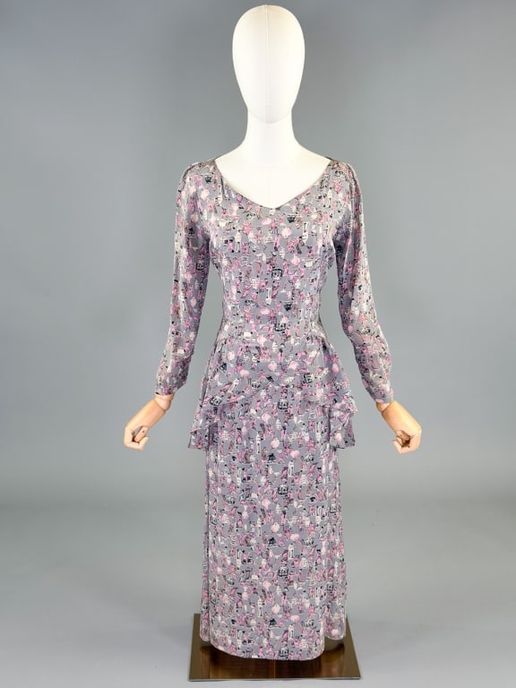 Vintage 1940s Silk Ancient Greek Print Dress: Vintage 1940s Silk Ancient Greek Print Dress having print throughout with peplum at waist, closing at center back with zip. Measuring 36-38 inch bust, 26-28 inch waist, 45 inches long, 22 inch sleeve 