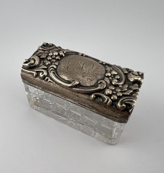 Antique Sterling Silver Repousse Lid Vanity Box: Antique Sterling Silver Repousse Lid Vanity Box. Measures 3 inches in width. Crystal base with cut star pattern. Lid acid tests as sterling silver.