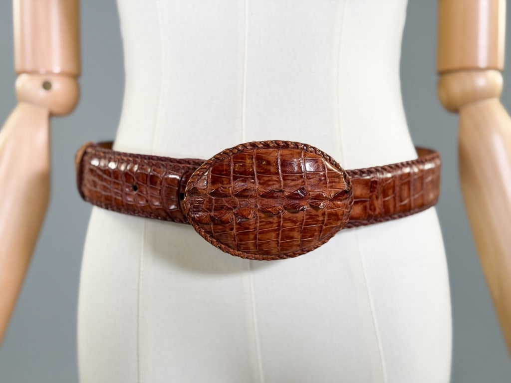 Vintage 1970s Brown Crocodile Leather Belt: Vintage 1970s Brown Crocodile Leather Belt having oversize oval buckle hook closure, measuring 32.5, 34 35.5, 37 inch waist respectively, 42 inch total length. Marked size 34.