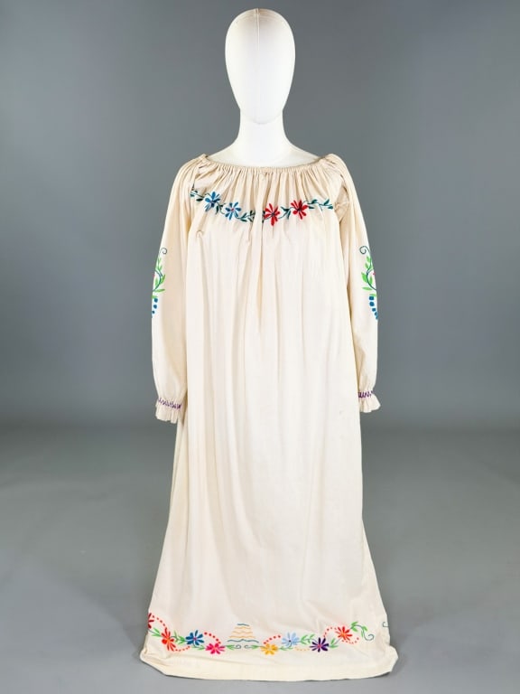 Vintage 1970s Mexican Floral Embroidered Dress: Vintage 1970s Mexican Floral Embroidered Dress having ruched neckline with floral embroidery throughout. Measuring 36-40 inch bust, 53 inches long, 21 inch sleeve length. General wear as shown through