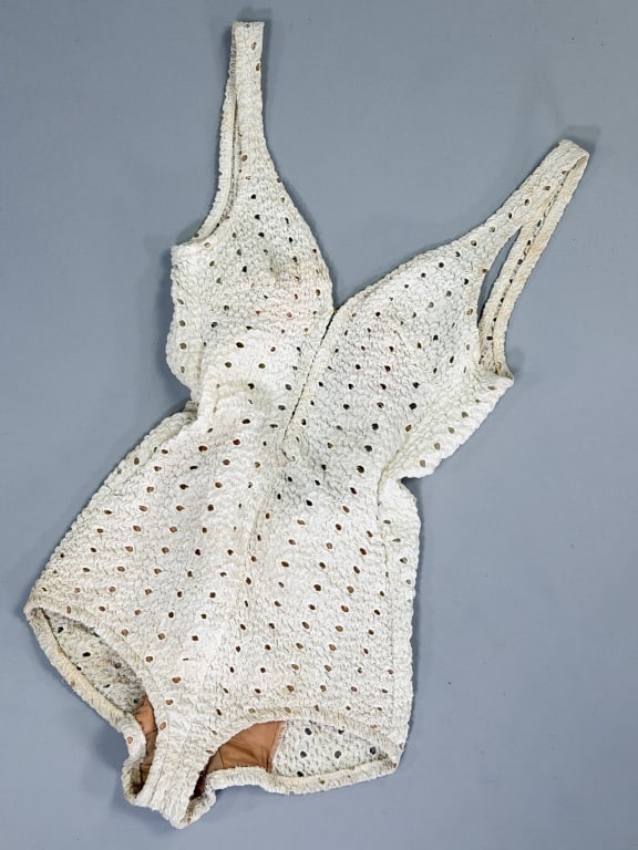 Vintage 1960s Elastic Eyelet Bathing Swim Suit: Vintage 1960s Elastic Cotton Eyelet Bathing Swim Suit having elastic thread throughout with hook closure up center front. Measuring 32-40 inch bust, 24-30 inch waist, 30 inches total length. General w