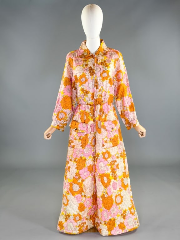 Vintage 1960s Psychedelic Floral Quilted Jumpsuit: Vintage 1960s Psychedelic Floral Quilted One Piece Jumpsuit having collar at neck with a zip front closure, two pockets at hips and elastic waist. Marked size 18. Measuring 42 inch bust, 28–40 inch 