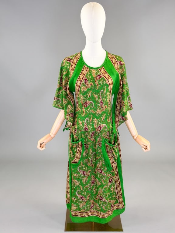 Vintage 1970s Paisley Bias Cut Hippy Dress: Vintage 1970s Paisley Bias Cut Hippy Dress having fluttered sleeves, two front pockets, bias cut with stretch throughout body, no closures slides over head. Measuring 32-50 inch bust, 26-44 inch waist