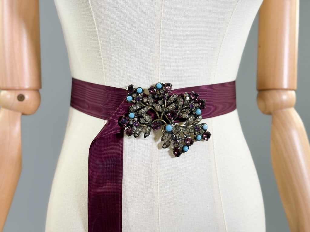 Vintage Austro Hungarian Style Rhinestone Belt: Vintage Austro Hungarian Style Rhinestone Belt having paste stones throughout with moire ribbon belt. Buckle measuring approximately 4 inches long.