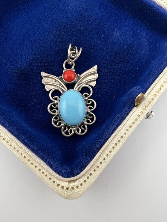 Native American Sterling Turquoise Coral Pendant: Native American Sterling Turquoise Coral Pendant. Sterling silver butterfly design necklace pendant with turquoise and coral cabochons. Hallmarked faintly on the back. Stones may be created / enhanced